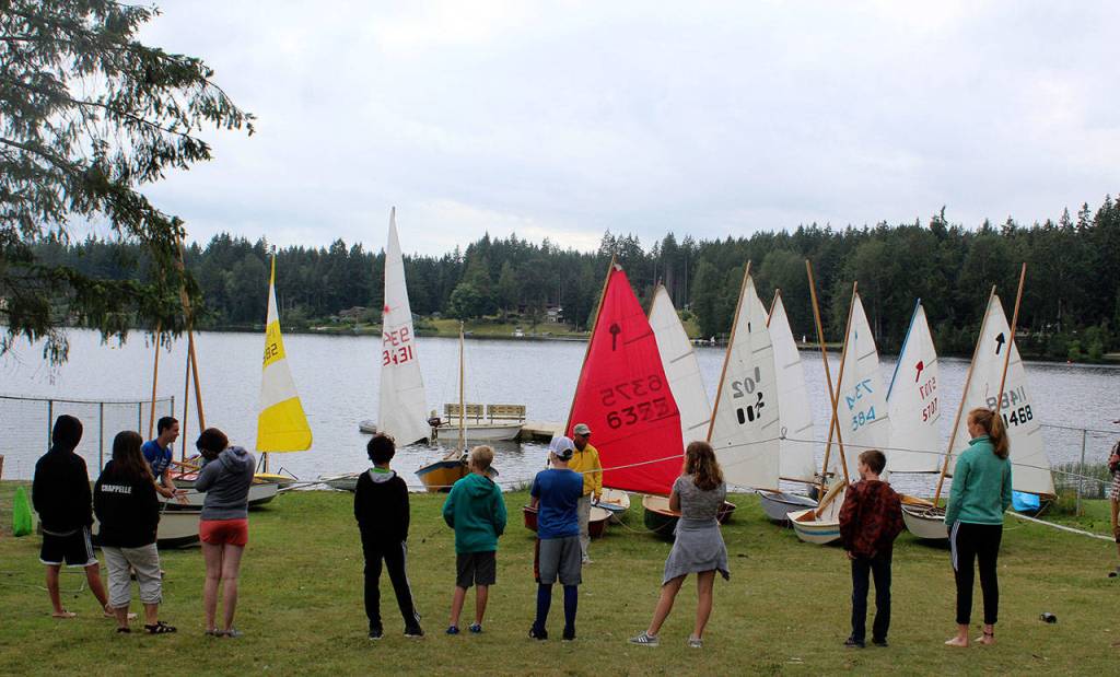 Students in a recent beginning sailing class on Deer Lake line up to play a game that teaches balance. They spend a couple hours each day in the little wooden El Toros 8-foot boats learning the ropes and how to read wind and current. Classes are taught by the South Whidbey Yacht Club through South Whidbey Parks and Recreation.