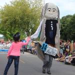 Photos by Patricia Guthrie / Whidbey News Group                                A girl gives a high-five to really tall Benjamin Franking during the Maxwelton Fourth of July Parade.