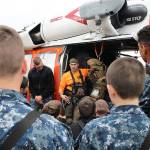 Corpsman John Siedler, of NAS Whidbey Island SAR, speaks to a group of Sea Cadets Thursday morning. He and other members of the unit discussed the job, the equipment and answered questions during that cadets summer training at Camp Casey Conference Center. Photo by Laura Guido/Whidbey News-Times