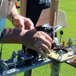 Leonard Good sets up a students rocket on his trusty handmade rocket launcher platform. Its decorated with miniature astronauts and resembles a NASA space center.