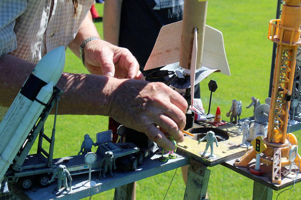 Leonard Good sets up a students rocket on his trusty handmade rocket launcher platform. Its decorated with miniature astronauts and resembles a NASA space center.