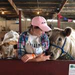 Photo by Emily Gilbert/South Whidbey Record.                                Samantha Ollis, of Langley, with her cows Duke, left, and Daisy, which shes raised.