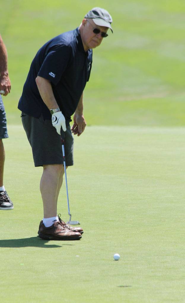 Tom Davis taps a putt toward the hole.(Photo by Jim Waller/South Whidbey Record)