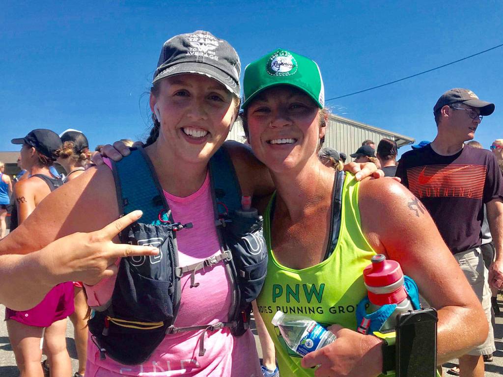A runner from another team, Sarah Webb, left, saw Megan Benjamin struggling to finish her final leg and ran beside her to help Benjamin complete the run. The pair competed on the same Ski to Sea team earlier this year. (Submitted photo)