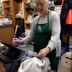 A volunteer rings up a purchase at Senior Thrift, which is operated by Island Senior Resources as a revenue source to support its numerous programs and services. The nonprofit agencys Together We Care, campaign is attempting to raise $10,000 on Aug. 1. (Photo provided)