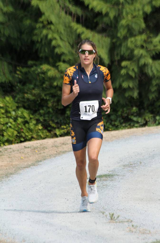 Heather Ireland, who is stationed at Naval Air Station Whidbey Island, runs to first place among women at Saturdays triathlon. (Photo by Jim Waller/South Whidbey Record)
