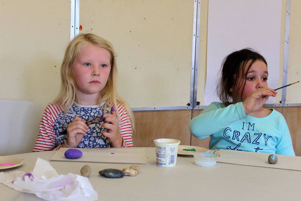 South Whidbey Community Center has transformed Langleys old school into a hub of organizations and activities including social services, learning, creating, playing, cooking and baking. Pressley Moss, 7, left, and Nicholle Sargent, 8, paint rocks as part of Mindfulness Monday, one of many daily programs offered through the summer.