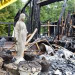 A Virgin Mary statue stands, mostly undamaged, among the remnants of a house that burned down Thursday night in Freeland. The cause is being investigated and no one was injured. Photo by Laura Guido/Whidbey News Group