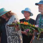 Honoring orcas captured in Penn Cove and the lone survivor, Tokitae, are Cindy Hansen, far left, Susan Berta, Jan Bell, center, and Howard Garrett. The annual ceremony was held Wednesday at the Coupeville Wharf. (Photo by Patricia Guthrie/Whidbey News-Group)
