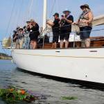 Flowers, cedar boughs and a wreath float away from, Suva, the schooner that took whale advocates to the Penn Cove site where pods of orcas were herded and trapped in 1970 and 1971. (Photos by Patricia Guthrie/Whidbey News-Group)