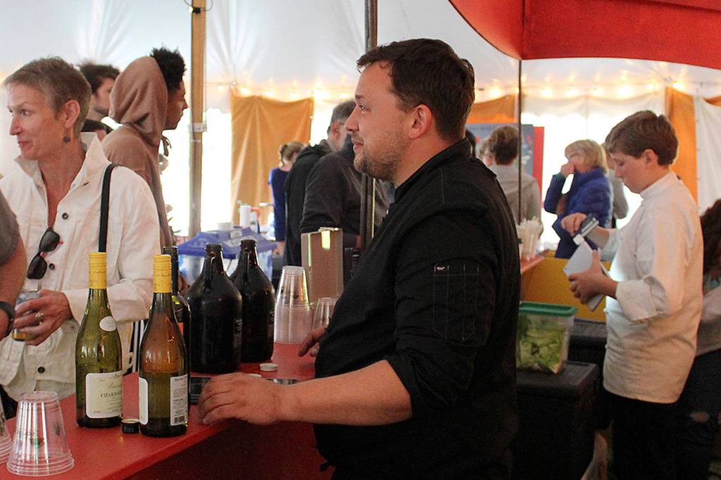 David Phillips pours wine and beer while Caelan Boyd serves food during Island Shakespeare Festival performances.