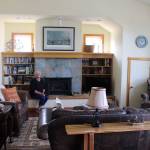 Susanne Paulson sits in the living room of the two-bedroom apartment, The Carriage House, above her garage that she rents out to Langley visitors. Located on First Street, downtown is just a block away. Photo by Patricia Guthrie/Whidbey News Group