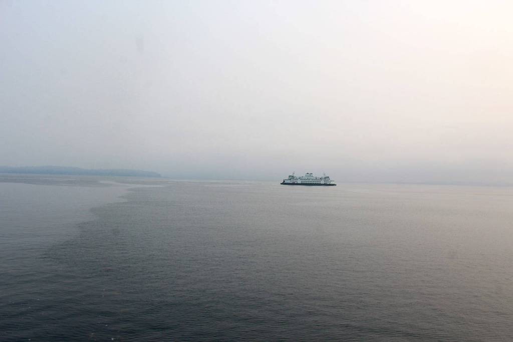 A ferry heading out of Clinton Monday morning is almost lost in the regional haze coming from hundreds of wildfires burning in Canada, Oregon and central Washington.