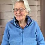 Edythe Swanson will turn 100 in September. She stands here outside her hosue in Clinton.
