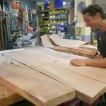 Photo by Emily Gilbert / Whidbey News-Times                                <em>Glen Pearson inspects the Maple wood slabs that will become the top of the table hes making for Woodpalooza this year. He said itll take him about 60 hours to have the table finished.</em>