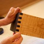 <em>Marian Quarrier holds a drawer that will go into an entertainment center shes making for this years show. She said she likes to use a variety of colors of wood in her pieces and many of her creations feature at least three.</em>