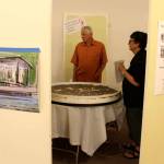 Jay Devenny talks about his creation called Sand Dabber  with Diane Divelbess at a Wednesday meeting discussing proposed improvements to Seawall Park. To the left is a drawing of his Middens shelter idea. (Photo by Patricia Guthrie/Whidbey News Group)