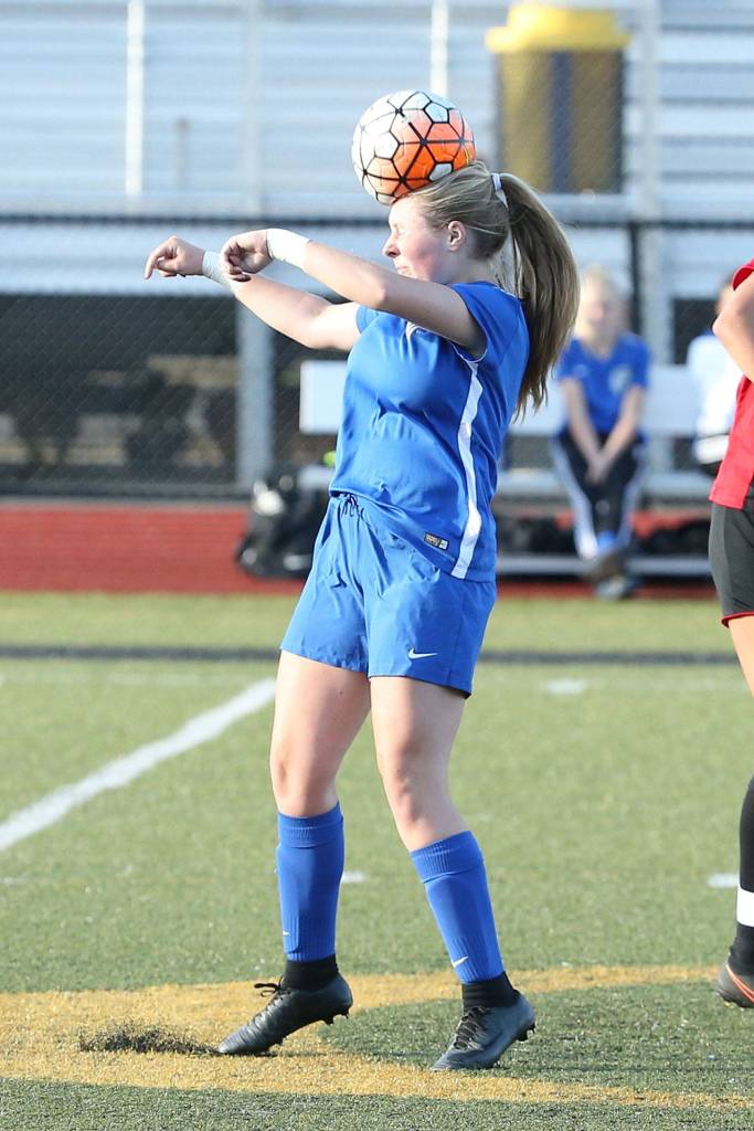 Maddy Drye heads the ball for the Falcons.(Photo by John Fisken)