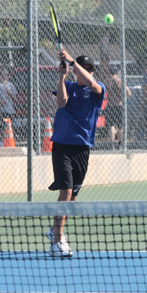 Joey Lane rips a shot in his win in first doubles.(Photo by Jim Waller/South Whidbey Record)