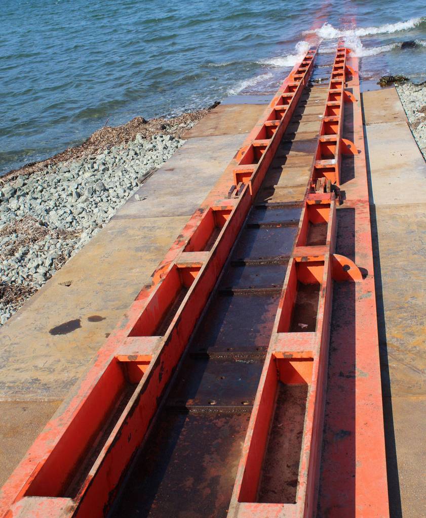 Two bright orange metal tracks extending from the shipyard to the sea will bear the weight of the 1,700-ton vessel.