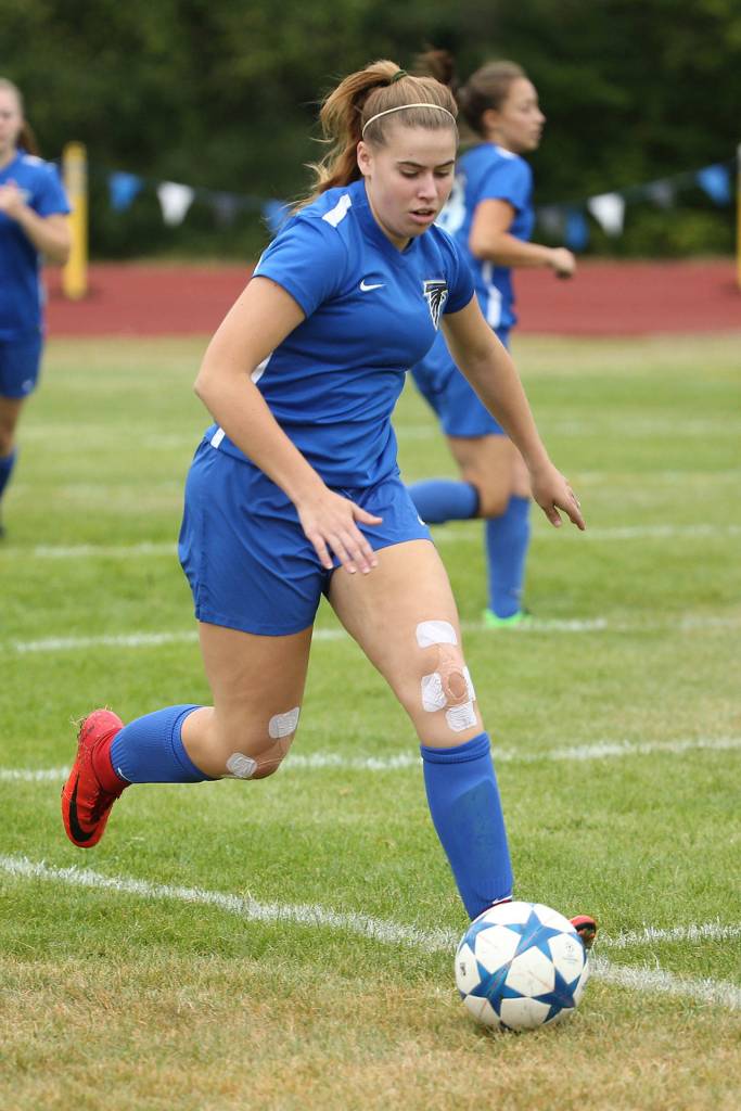Samantha Ollis runs down the ball for South Whidbey.(Photo by John Fisken)