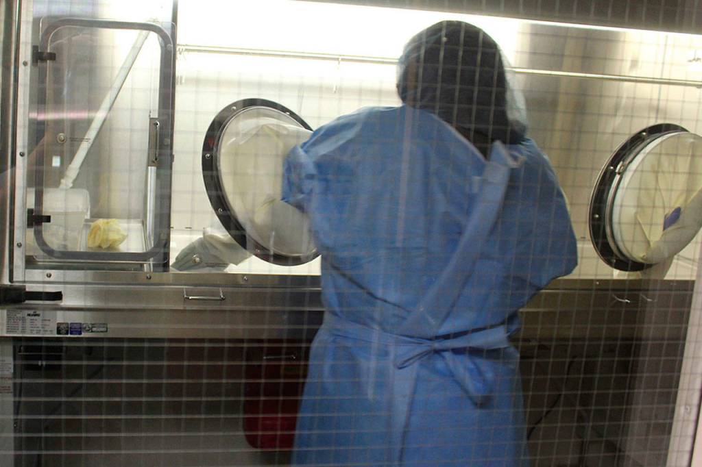 Pharmacy technician Julie Bellis reaches into a sterile chamber to make an order of penicillin for a hospital patient. A much more elaborate system for mixing antibiotics and chemotherapy drugs is needed because of new government safety guidelines. (Photo by Patricia Guthrie/Whidbey News Group)