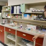 Clarke Cagingin, pharmacy technician, looks over the work station that all five staff members use in the hospitals current pharmacy. Six work stations were built into the new pharmacy, estimated to be five to six times bigger. (Photo by Patricia Guthrie/Whidbey News Group)
