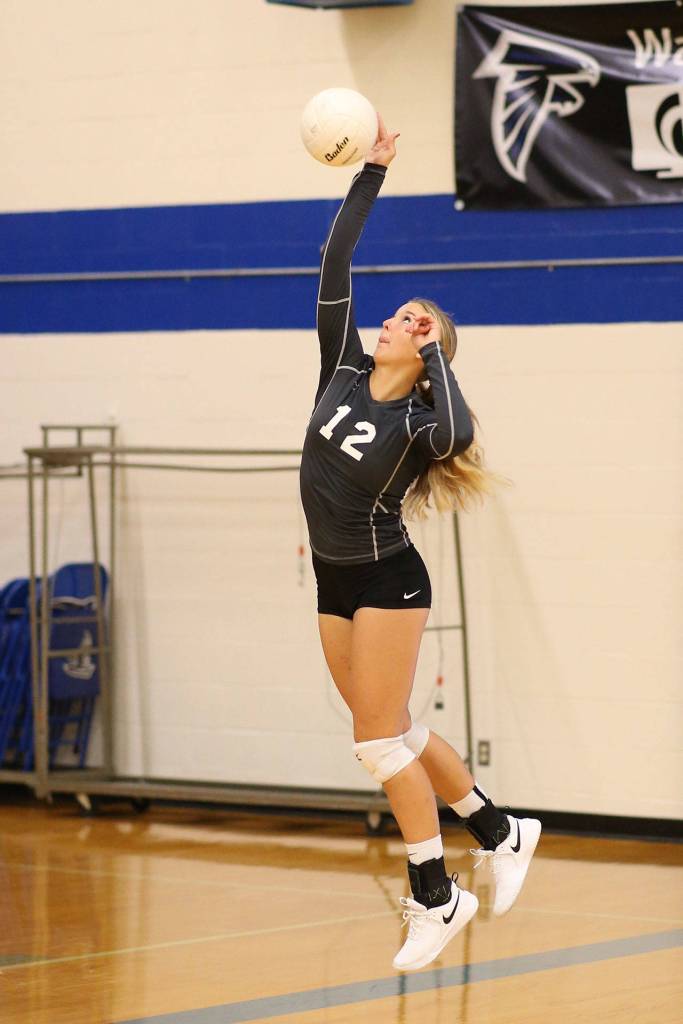 Emma Leggett serves for South Whidbey.(Photo by John Fisken)