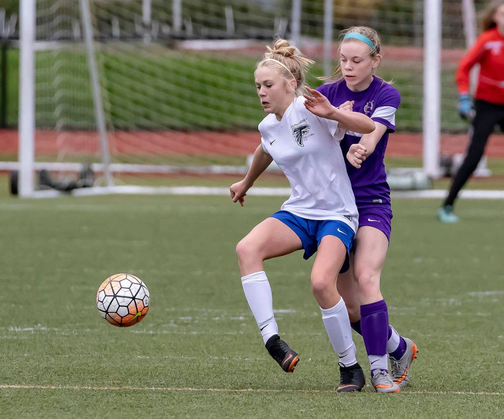 South Whidbeys Mikenna Wicher shields the ball from Oak Harbors Alexandra Palmer.(Photo by John Fisken)