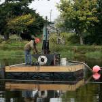Photo by Maria Matson / Whidbey News Group                                Mike Brown runs the machine that is extracting goose and duck poop from the bottom of the Greenbank Farm pond.