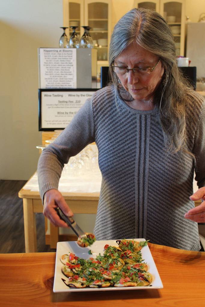 Virginia Bloom prepares to offer guests a sample of culinary creations made by chef Wayne Carter.