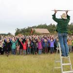 Jessie Stensland / Whidbey News Group                                Jen Pennington organizes a card stunt during a rally against Growler jet noise in Central Whidbey Wednesday.