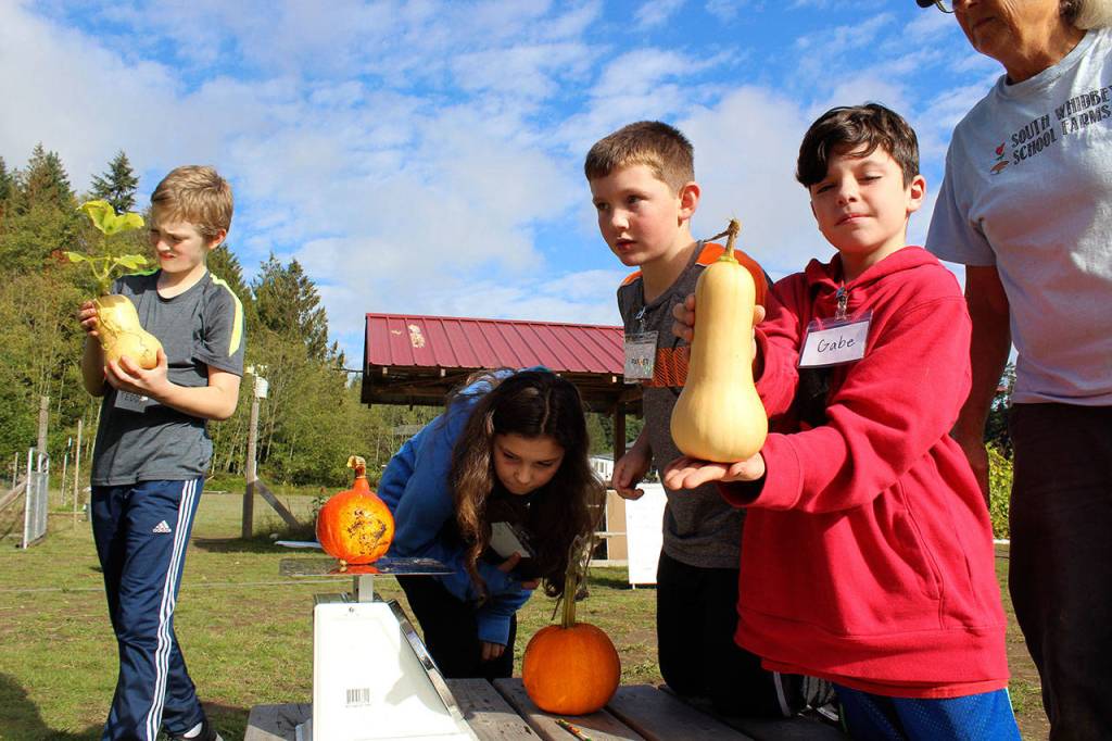 Gabe OBrien shows off his giant gourd picked Wednesday.