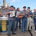 Photo provided                                The Shifty Sailors play at the Tall Ship Festival in Riga, Latvia in 2003 aboard the German sailing vessel Seute Deern. Pictured are Jim Amis, Mike Thelen, Wylie Vracin, Karl Olsen, Clarke Harvey, Vern Olsen (accordion), Ray Loe, Bruce Bardwell, Denny Armstrong (guitar), Jack Moeller and Peter Lawl.
