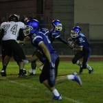 Billy Rankin (21) takes a handoff from Kody Newman.(Photo by Jim Waller/South Whidbey Record)