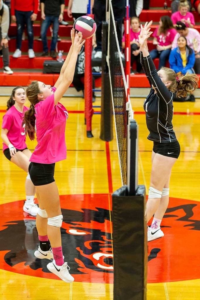 South Whidbeys Emma Hodson, right, rises in an attempt to block Emma Smiths tip.