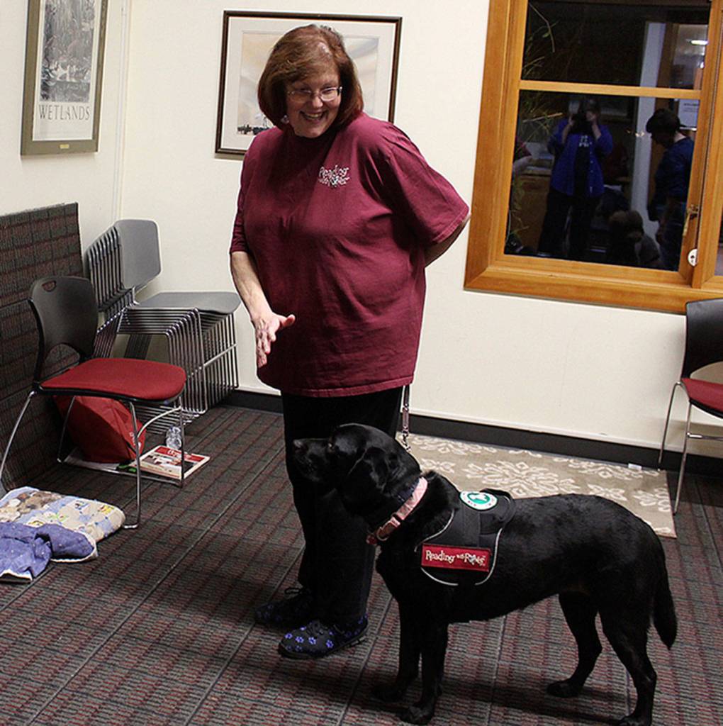 Trainer Diana Trupiano signals to her therapy dog, Milly, to wait.