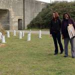 Sharon Young-Hale and Allenda Jenkins laugh as they read the humorous names featured in the cemetery, such as Ben Better, U.R Next, M.T Tomb, May B. Not and Asher T. Asher.
