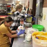 Olivia Livingstone, left, Kjersti Ringsrud, center, and Emery Fisher carefully measure ingredients for their pies. (Photo by Patricia Guthrie/Whidbey News Group)