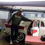 John Norris stands beside Miss Piggy, a camping trailer built from many spare parts of cars, trucks and motorcycles. It was assembled by Brian Woods of British Columbia.