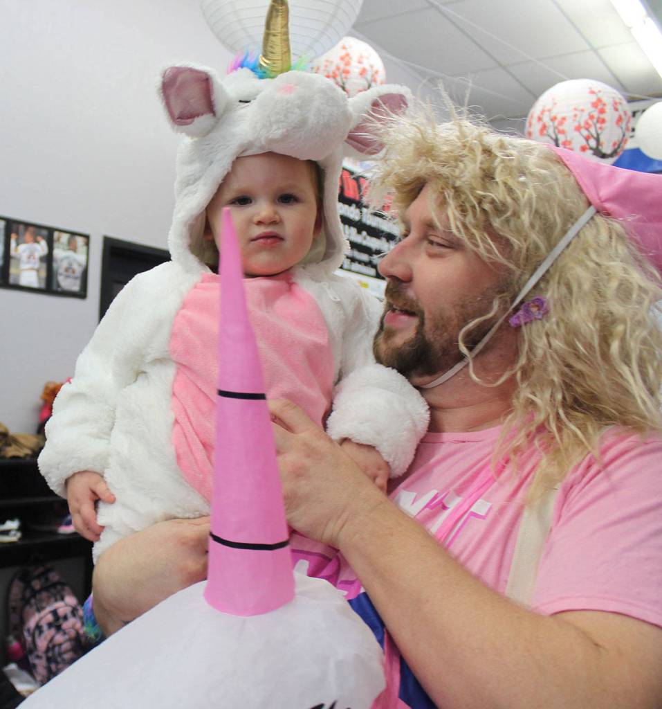 Dad Damien Cortez couldnt resist dressing as a unicorn for a Halloween gathering Tuesday at Armstrongs ATA Martial Arts Clinton school. As his two older children enjoyed a taekwondo class treat for their pink belt fundraising efforts, Cortez watched his youngest bunny.