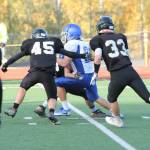Caden Spear looks for some running room as Meridians Tanner Bouwman (45) and Dylan Hickok (33) close in.(Photo by Jim Waller/South Whidbey Record)