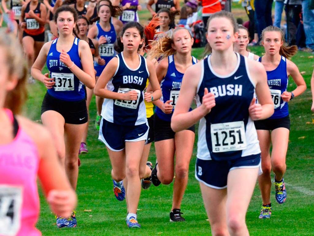 South Whidbeys Flannery Friedman, left; Laila Gmerek, center; and Natalie Rodriguez, right; navigate through the mass of runners. (Photo by Karen Swegler)