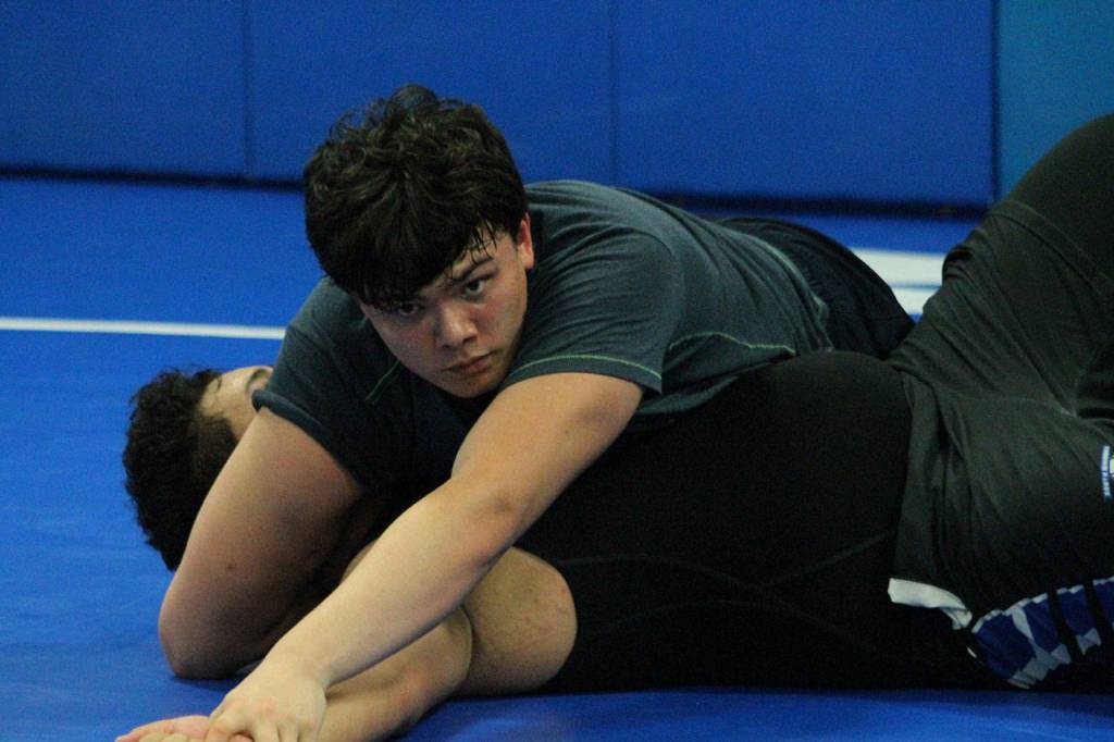 Junior wrestler Dylan Davis watches the coaches as he works on technique in practice Monday. (Photo by Jim Waller/South Whidbey Record)