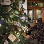 Dana Sawyers hangs shiny ribbon angels made to benefit the Whidbey Veterans Resource Center. (Photos by Patricia Guthrie/Whidbey News Group)