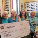 Lighthouse Environmental Programs staff present a $3,000 donation to Orca Network volunteers.                                Left to right: Lighthouse president Rick Blank and staff Ellen Dickey, Wendy Visconty and Orca Network founder Susan Berta and volunteers Shari Devlin and Wendy Sines. (Photo provided)