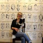 Meredith MacLeod poses with her dog, Mica, in front of some of her portraits. On Jan. 1, shell talk about the public response to the interactive art exhibit. Photo by Patricia Guthrie/Whidbey News Group)