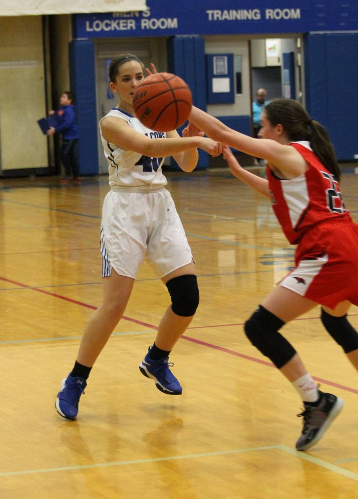 Sammi Daly, left, throws an entry pass to get the offense started.(Photo by Jim Waller/South Whidbey Record)