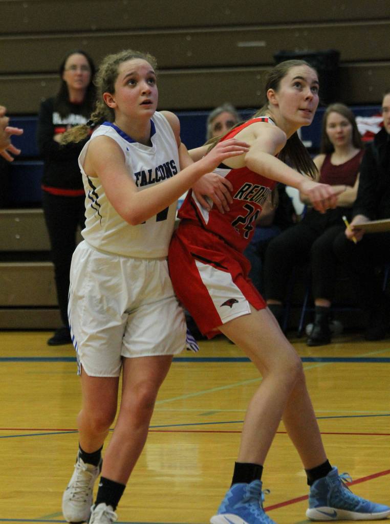 Ashley Lynch, left, tries to slip around the blockout of Port Townsends Maya Dow on a Falcon free throw.(Photo by Jim Waller/South Whidbey Record)