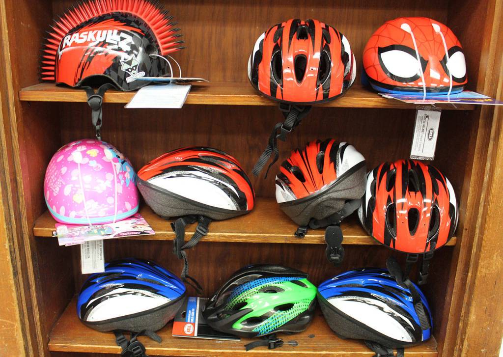 Helmets await to go out with door with new bicycles, along with a lock for each bike.